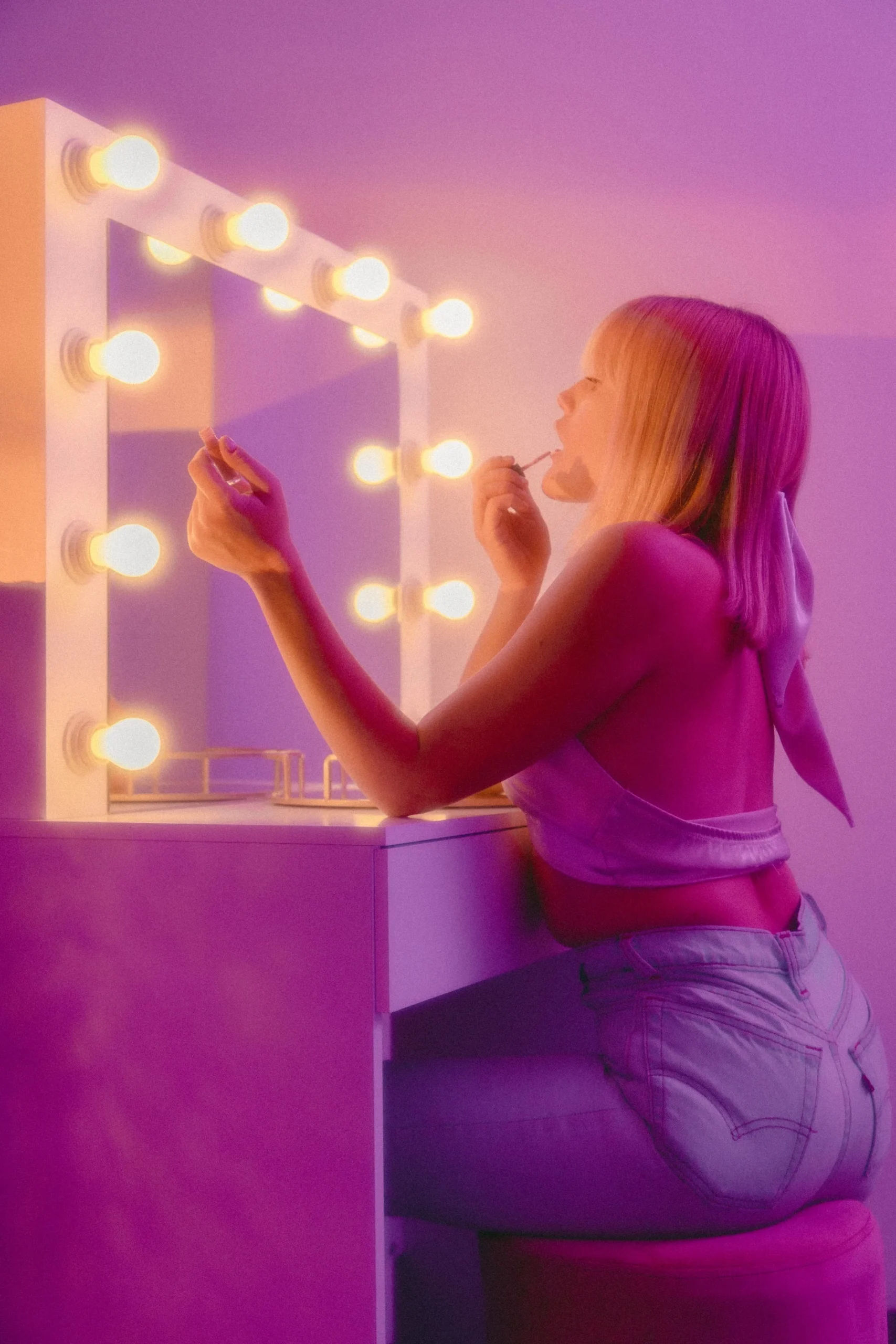 Girl in front of a mirror applyig makeup